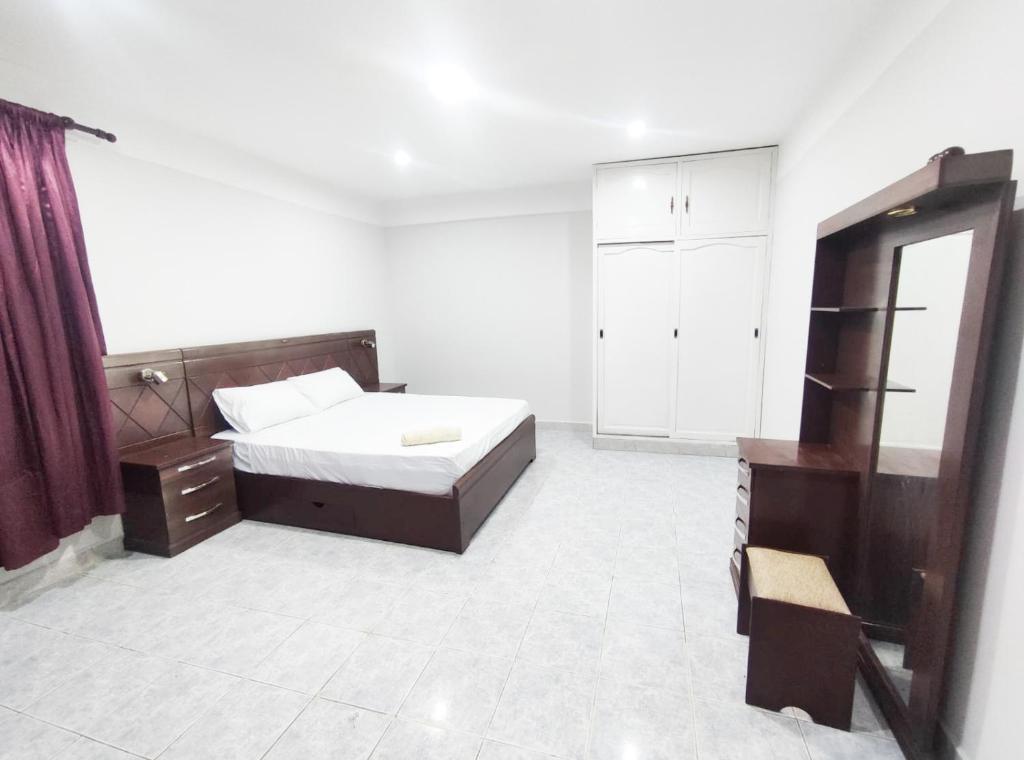 a bedroom with a bed and a dresser and a mirror at Depa in Tarija