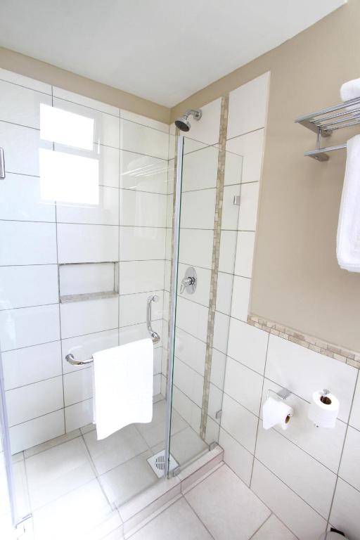 a bathroom with a shower with a glass door at Hotel Rio in Nairobi