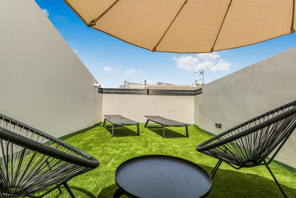 two chairs and a table on a roof at Living Central Stay Bejeque in Vecindario