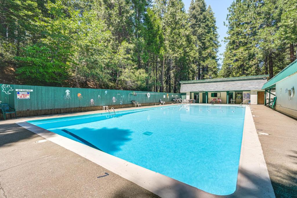 a large swimming pool with blue water in a yard at Hike, Swim, Golf Family Retreat in Arnold! in Arnold