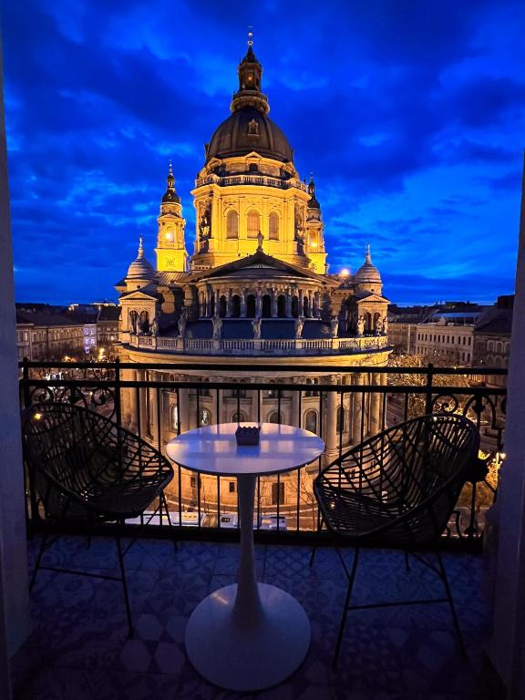a table in front of a building at night at Basilica Panorama Luxury in Budapest