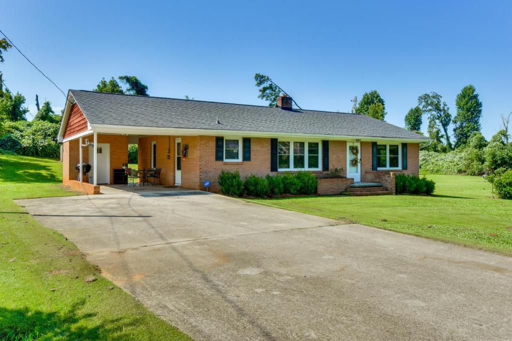 a house with a driveway in front of it at 8 Mi to Clemson Peaceful Family Home with Yard in Seneca