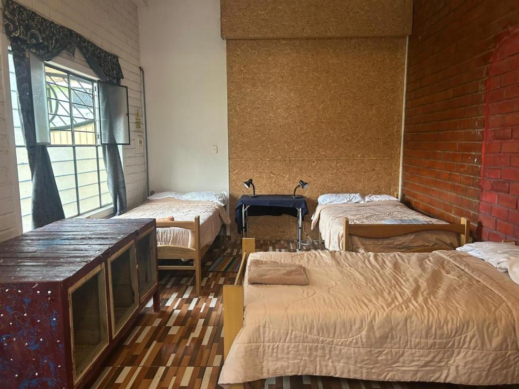 Postel nebo postele na pokoji v ubytování Hostel "La Casa de Ricky"