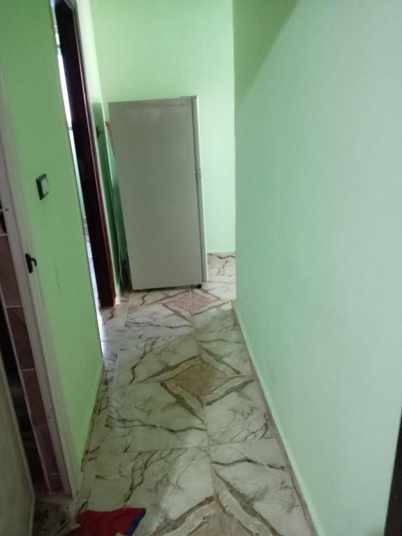 an empty room with a door and a marble floor at Enjoy 2025 in Alexandria