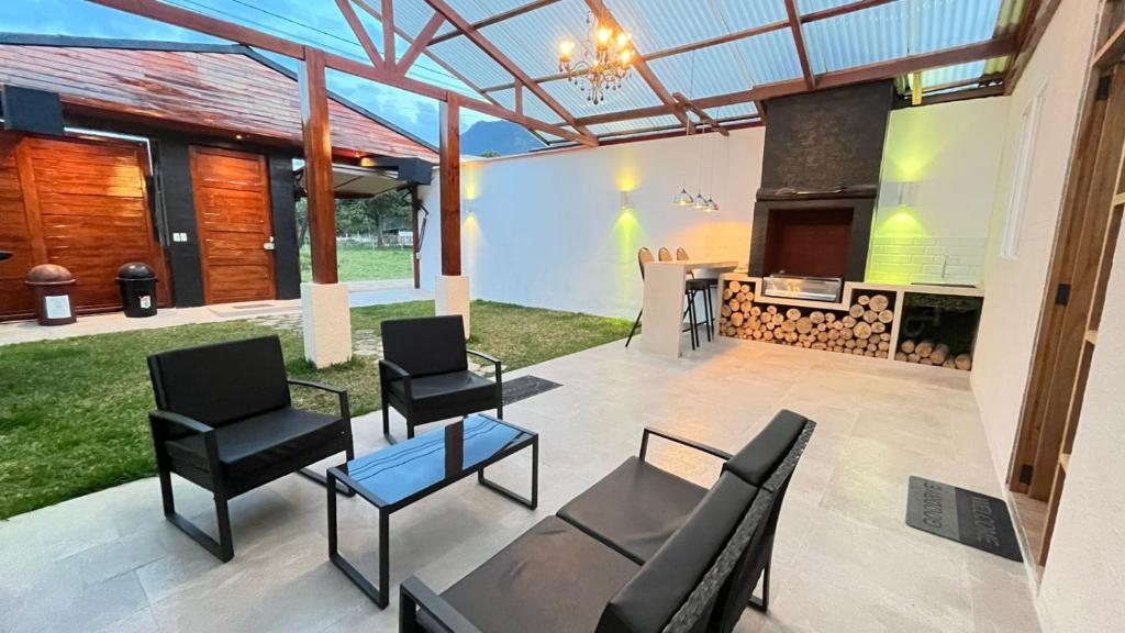 a patio with chairs and a table and a stove at C4s4 RANCH OXAPAMPA in Oxapampa