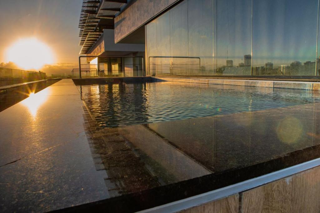 a large swimming pool on the side of a building at Newly 1 bedroom apartment by Galeria 360 in Santo Domingo