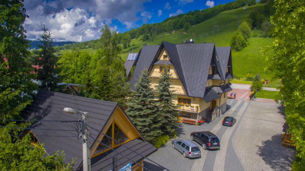 an aerial view of a house with cars parked in a parking lot at D.W Teresa in Zakopane
