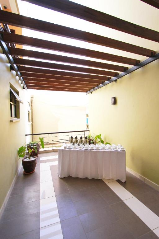 a long table with a white table cloth in a room at Hotel Rio in Nairobi