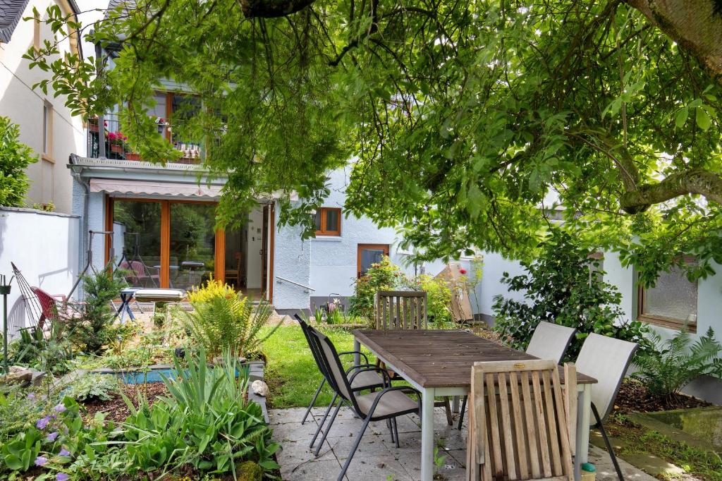 un jardín con mesa de madera y sillas en Ferienwohnung mit Garten, en Andernach