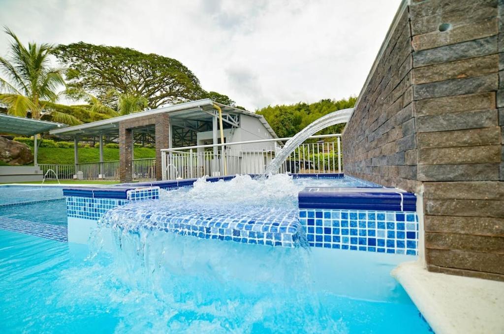 a swimming pool with a water slide in a house at Alojamiento Rural San José in Cartago