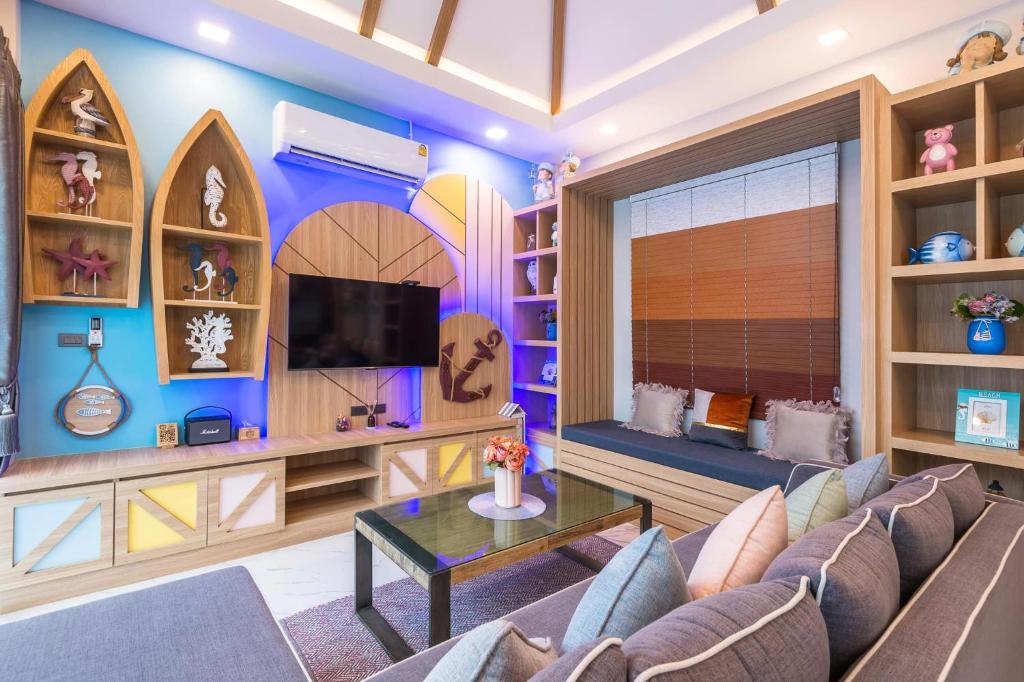 a living room with a couch and a table at The Tropical Pool Villas Ao Nang Group Krabi in Ao Nang Beach