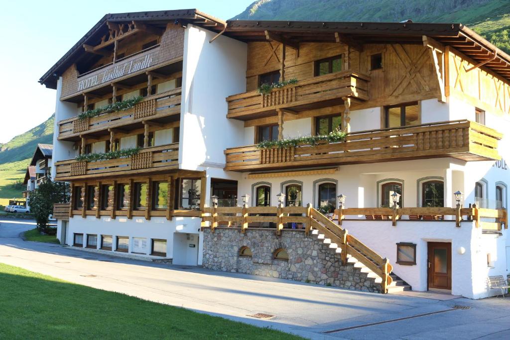 a large building with wooden balconies on it at Hotel Landle in Galtür