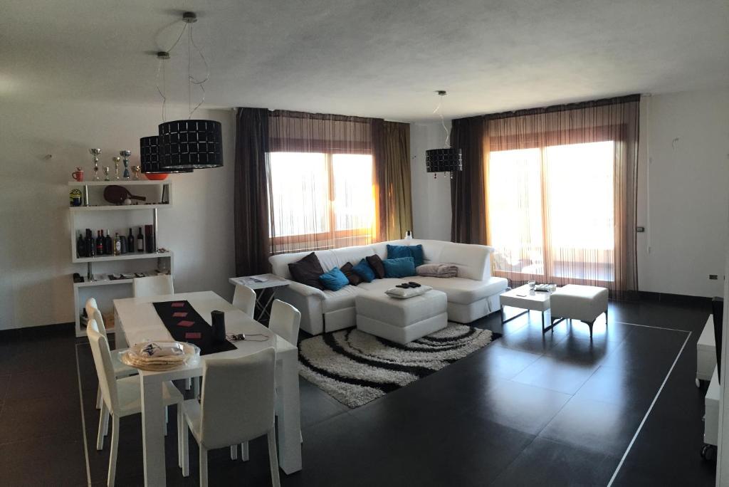 ein Wohnzimmer mit einem weißen Sofa und einem Tisch in der Unterkunft Alex House in Cagliari