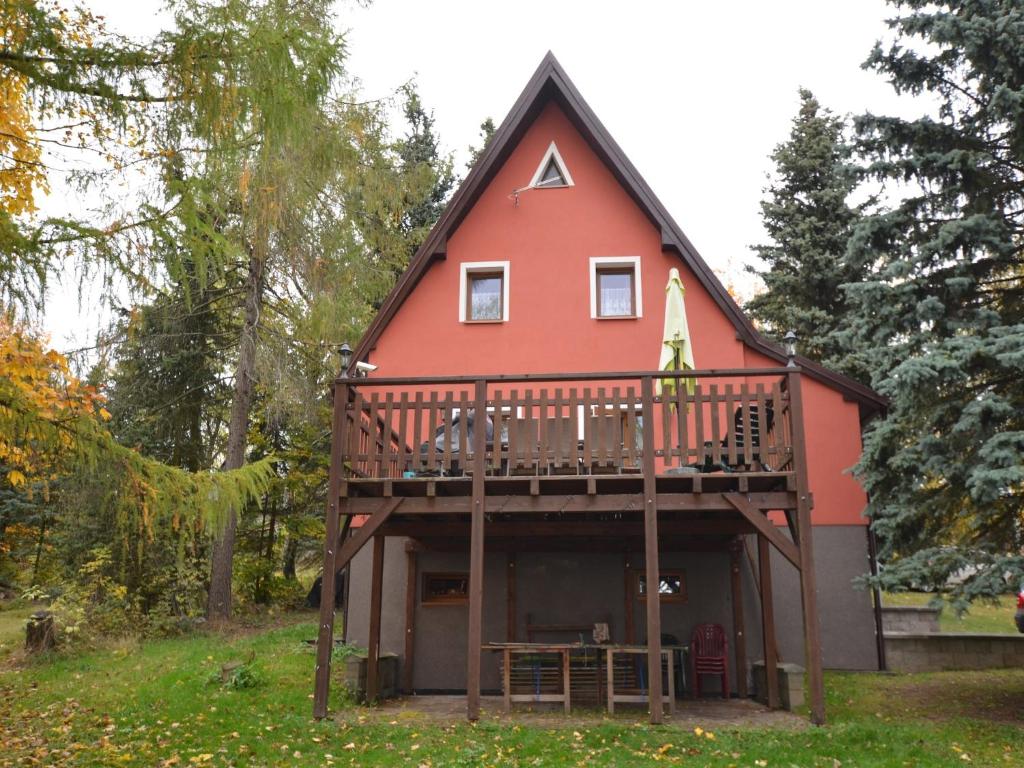 a large red house with a balcony and a deck at House in Bohemian near Ski Slope in Mezihoří