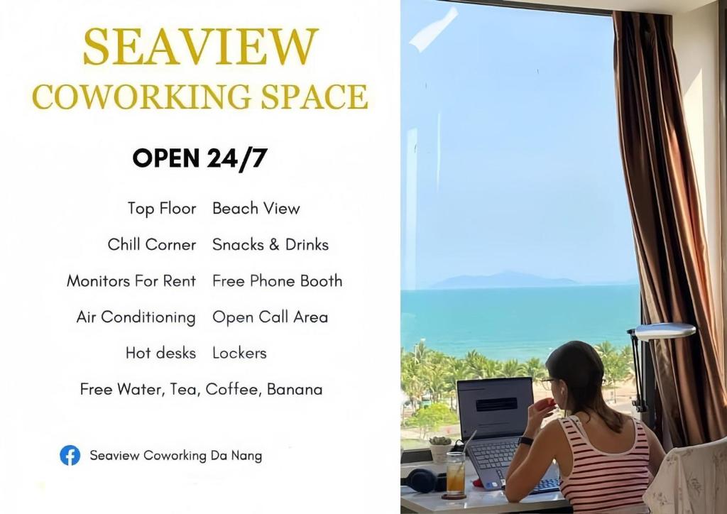 a woman sitting at a desk with a laptop at Waikiki Beach Hotel Da Nang in Da Nang