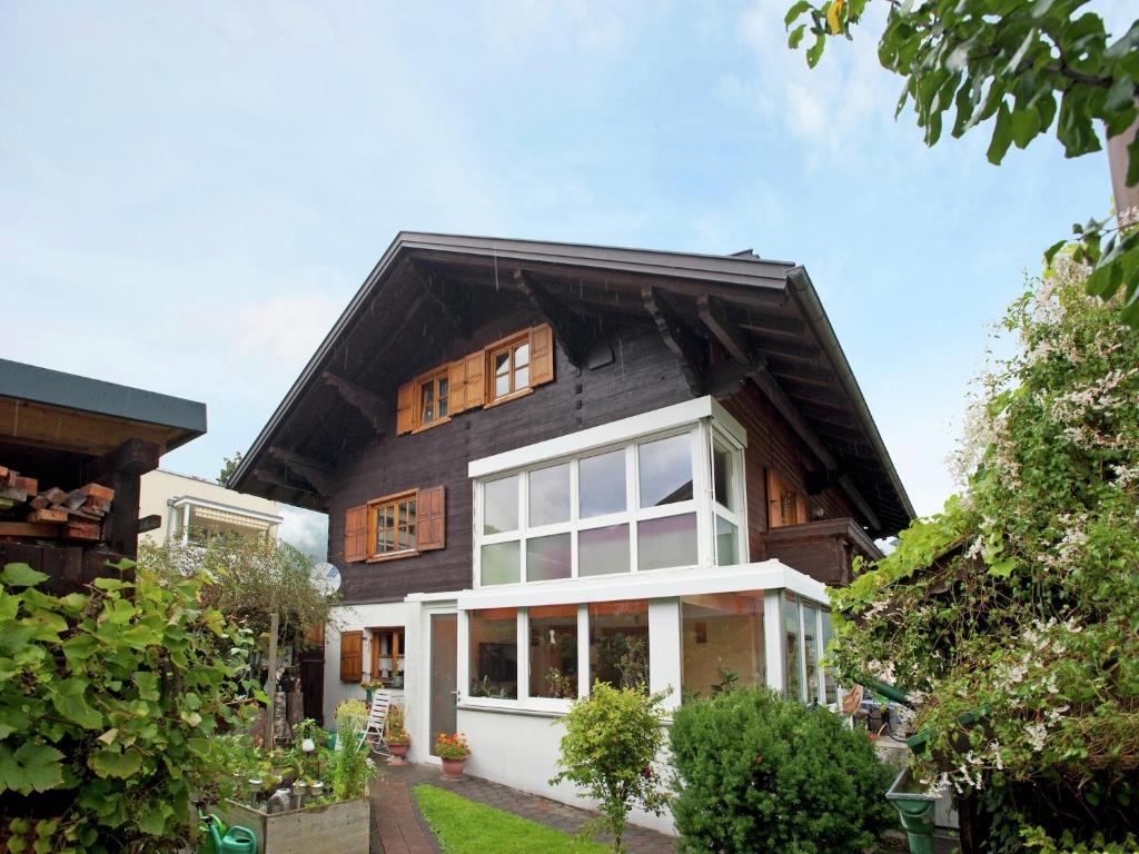 a house with a black roof at Apartment in Tschagguns near Ski Slopes in Tschagguns