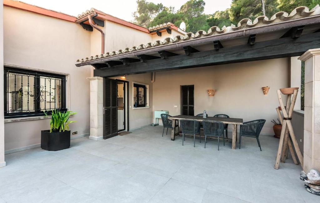 an outdoor patio with a table and chairs at Casa Soleada in Capdepera
