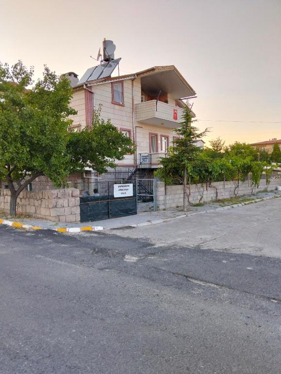 a house with a fence in front of a street at Kapadokya Denizhan Villa in Ürgüp