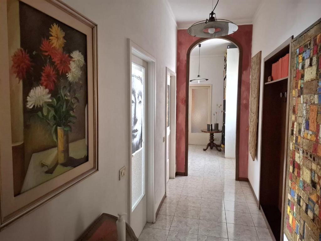 a hallway with a painting of flowers on the wall at Central Art House in Como