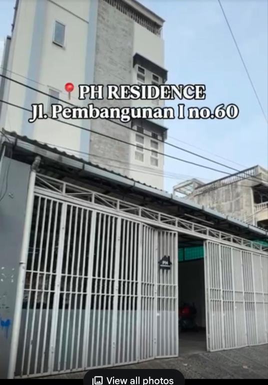 a building with a gate in front of a building at PH Residence Jakarta - Gajahmada in Jakarta
