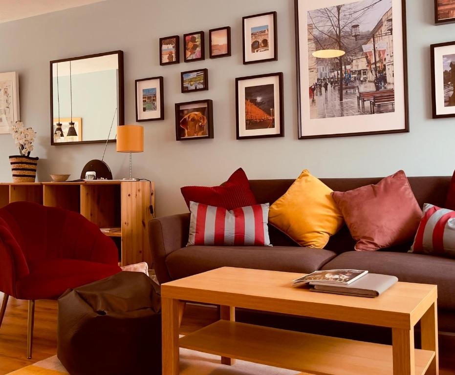 a living room with a couch and a table at Lovely 2 bedroom house in Bath with private parking garden WiFi & easy access to city centre in Bath
