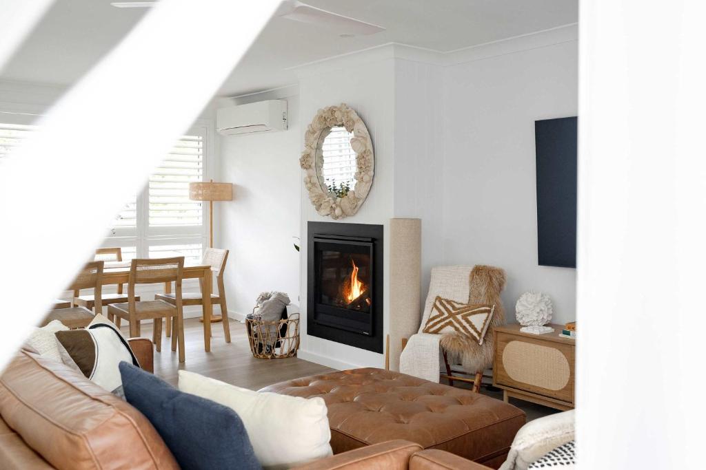 卡尔布拉海滩34° Degrees South Culburra的带沙发和壁炉的客厅