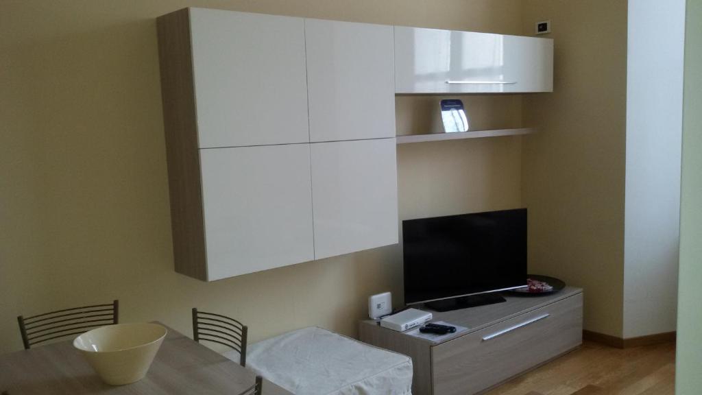 a dining room with a table and a tv at Appartamento Stefania in Milan