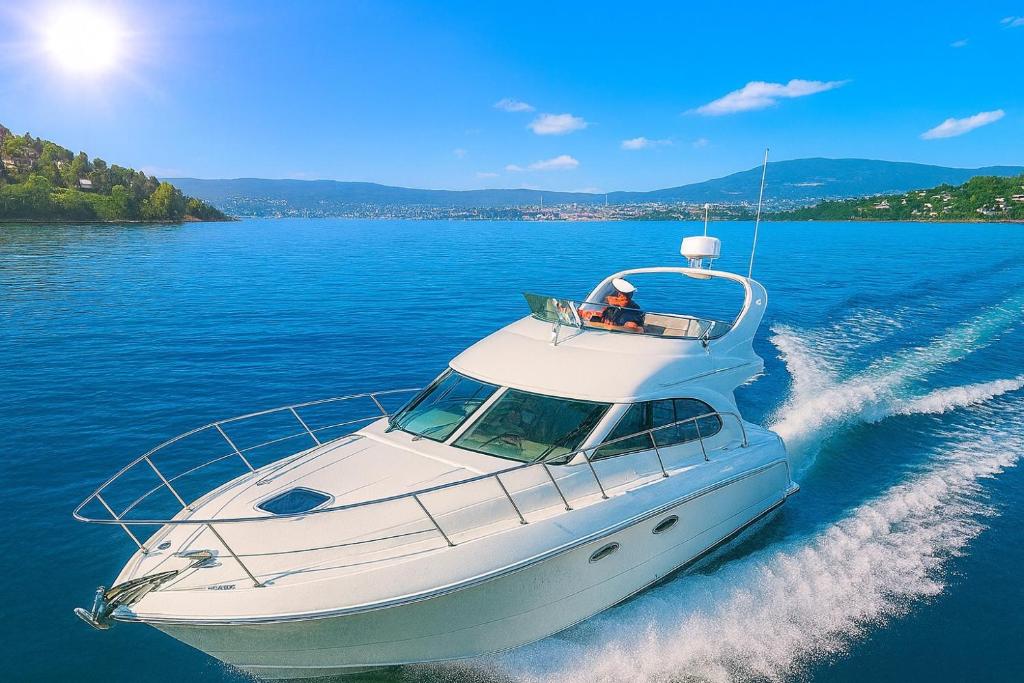a white boat in the water on a lake at Frognerstranda - Majestic- in Oslo