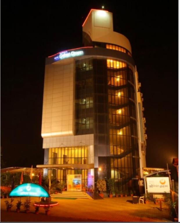 a large building at night with its lights on at Hotel Orient Crown, Kolhapur in Kolhapur