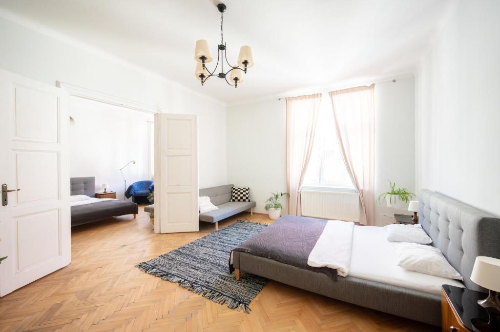 a bedroom with a bed and a living room at The City Gem in Bratislava