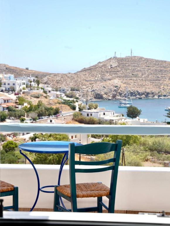 a table and chairs on a balcony with a view at View & Chill Syros in Vári