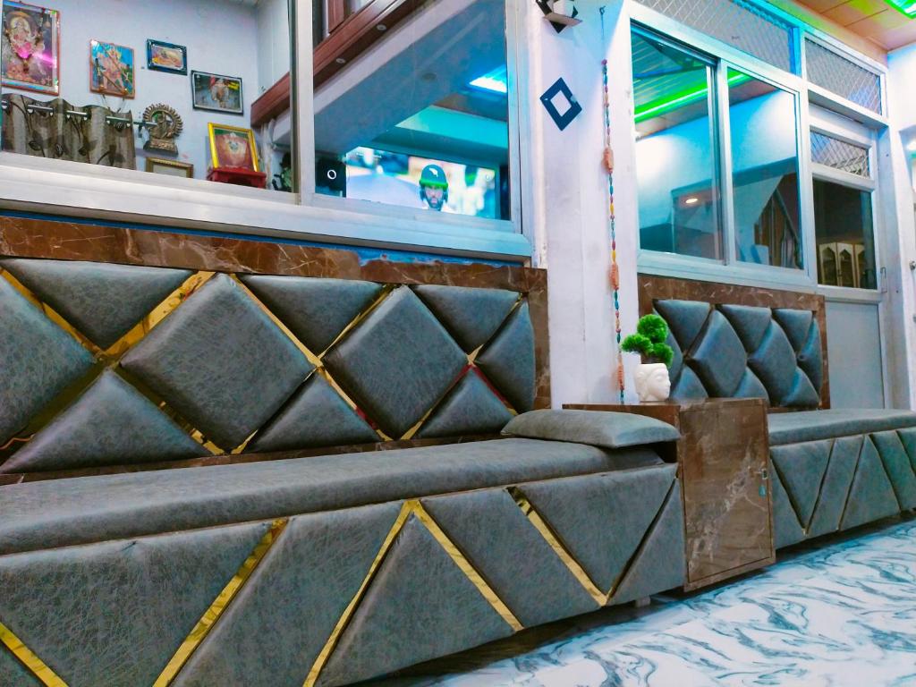 a seating area of a restaurant with a bench at Maa Vaishno Guest House in Varanasi