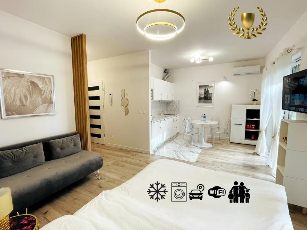 a living room with a couch and a kitchen at Apartment Barrier-Free in Kraków