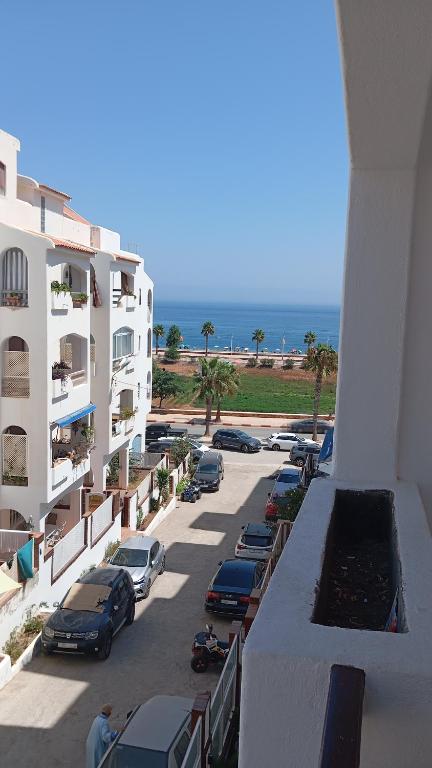 a parking lot with cars parked next to a building at B nadir in Tétouan