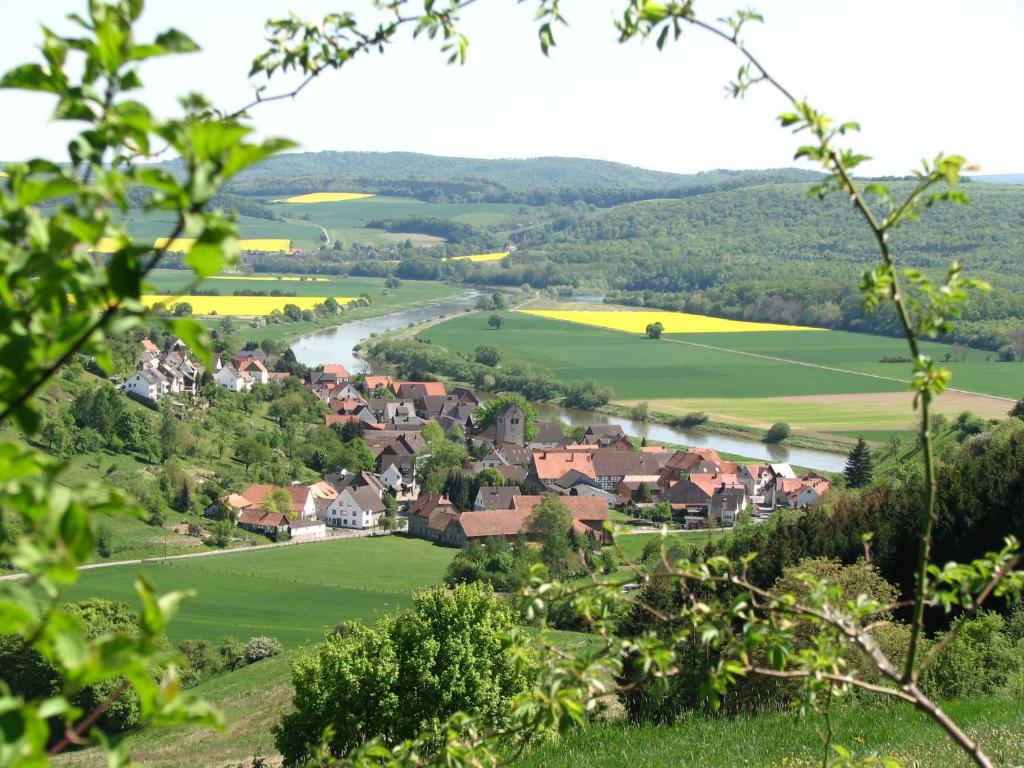 a village in the middle of a green valley at Ferienwohnung Lotz in Brevörde
