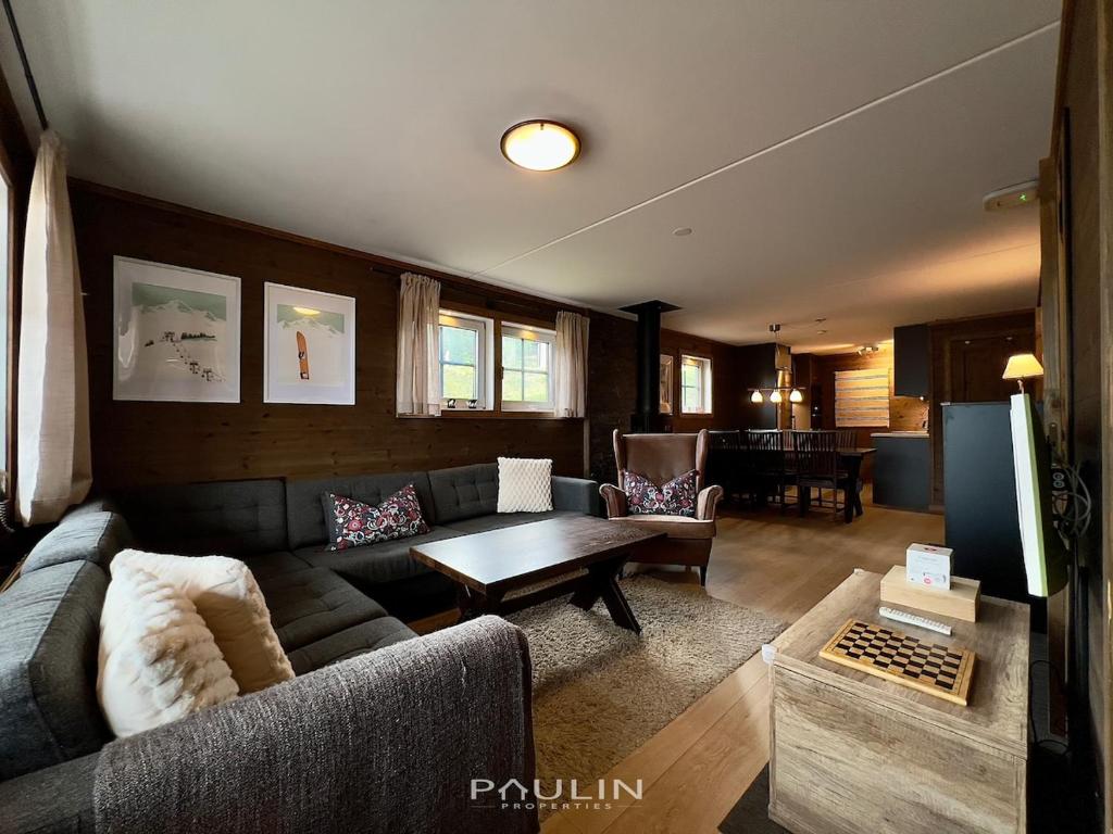 a living room with a couch and a table at Lindvallen Ski Resort - Sauna - 6 Guests in Sälen