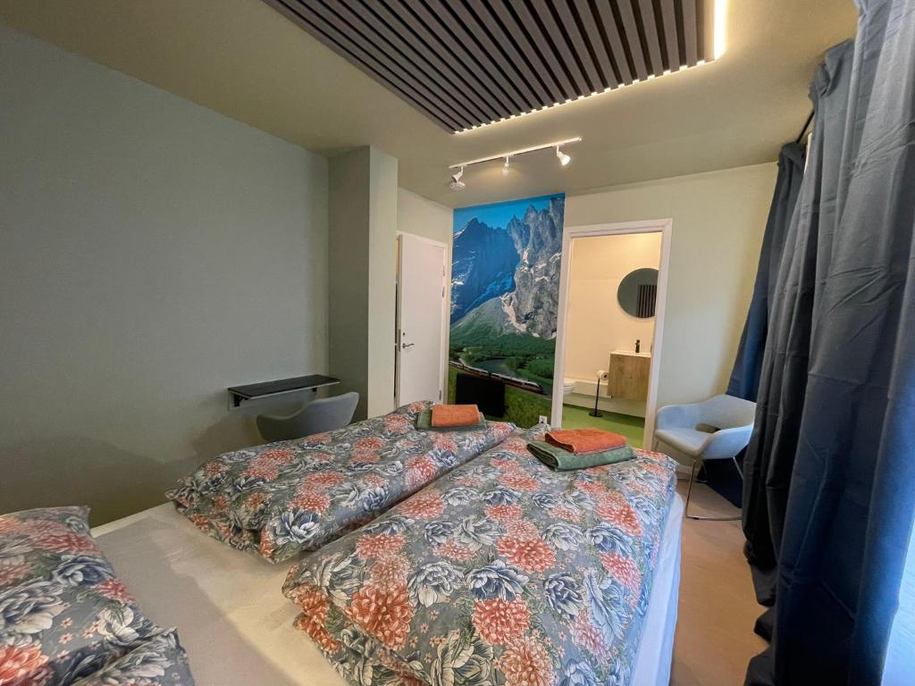 a bedroom with a bed and a painting on the wall at Bakkebo in Åndalsnes