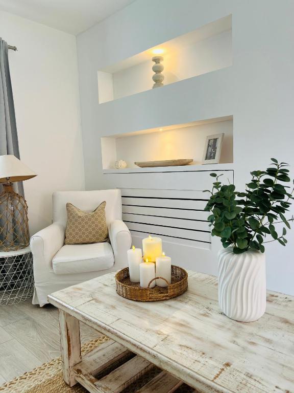 a living room with a table with candles and a chair at Southkey House in Repton