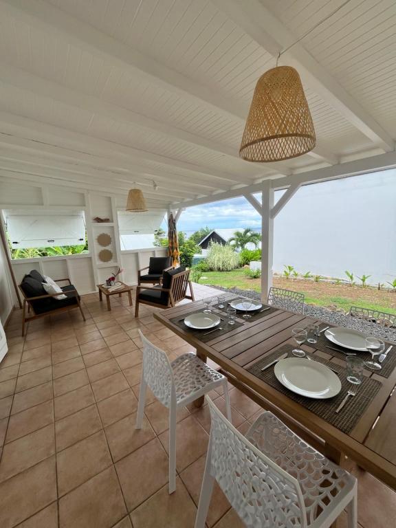 una sala da pranzo con tavolo e sedie di Bungalow Corossol a Deshaies