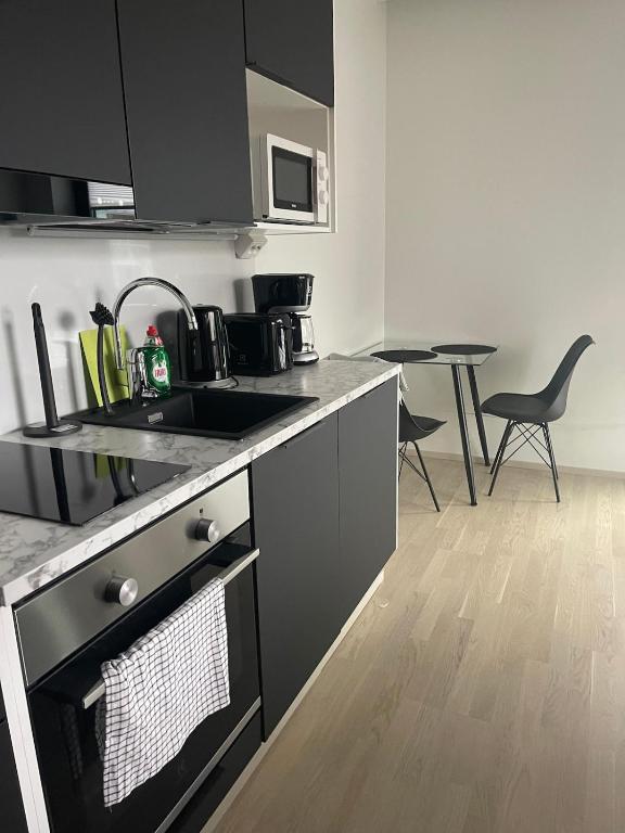 a kitchen with a sink and a counter top at Bright and cozy studio in Tampere