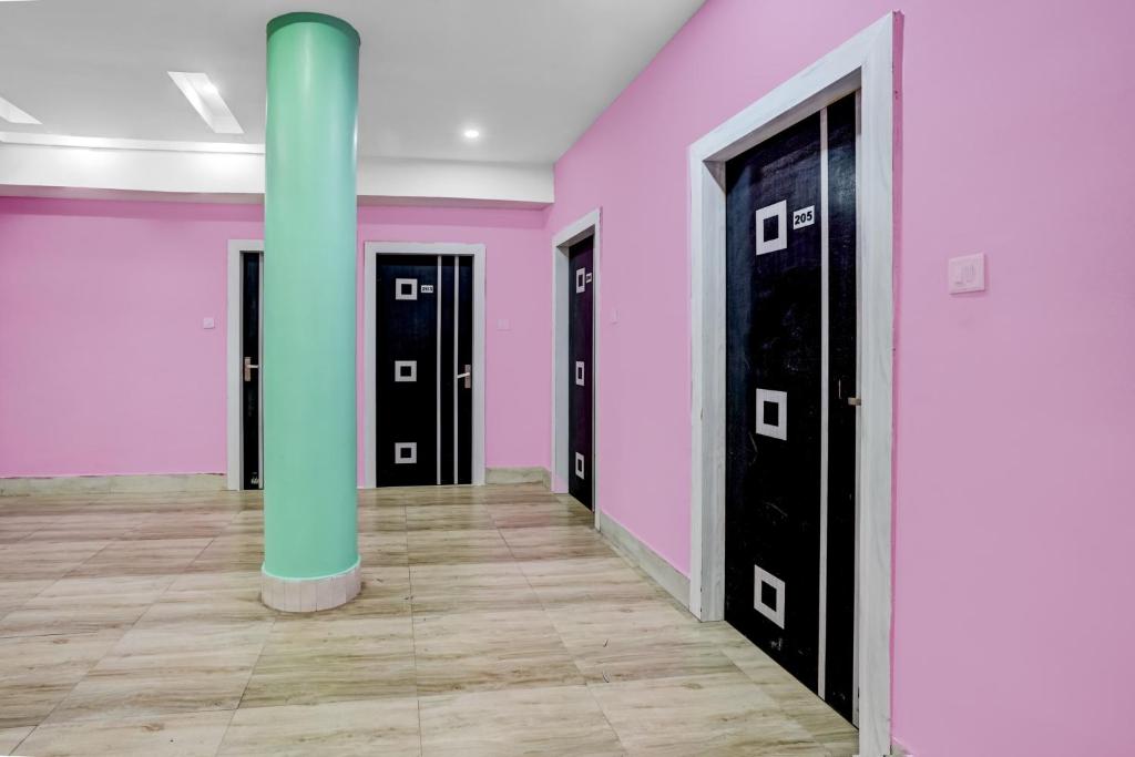 a room with pink and black doors and a pole at Super Collection O Harsh Regency in Rānchī