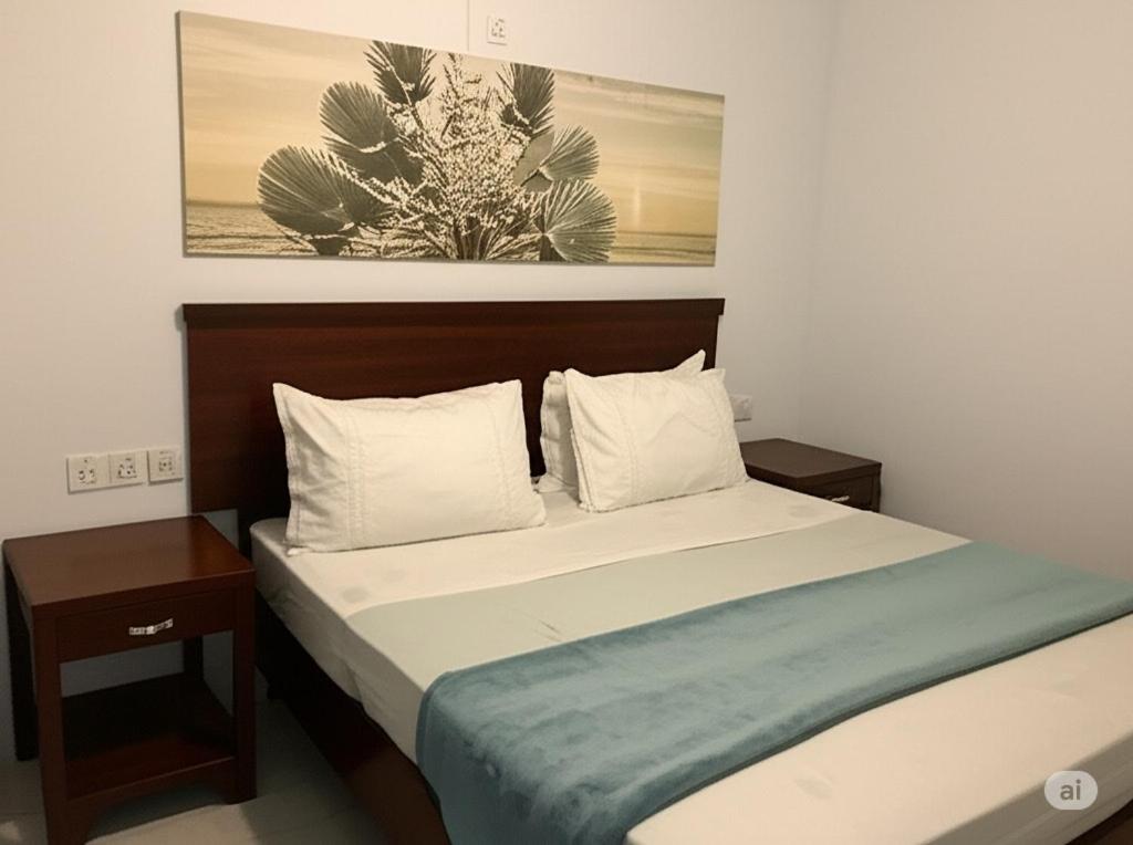 a bedroom with a bed with two tables and a painting at Pousada Caravela in Penha
