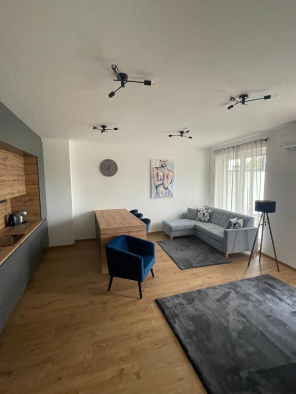 a living room with a couch and a table at Riverside Apartment Szeged in Szeged