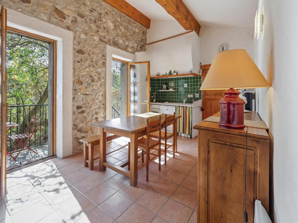 a kitchen with a table and chairs in a room at Holiday Home in Tautavel near Gorges & Museum in Tautavel
