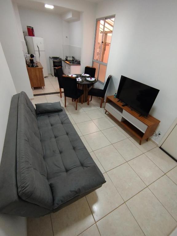 a living room with a couch and a television at Studio Premium in Franca