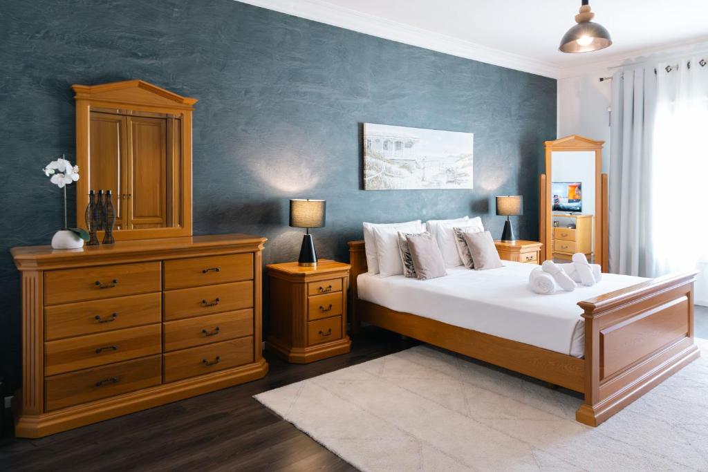 een slaapkamer met een groot bed met een dressoir en een bedsenalsenalsenal bij Top Location - 2BR Seafront & Steps from Ferry by ArcoBnb in Sliema