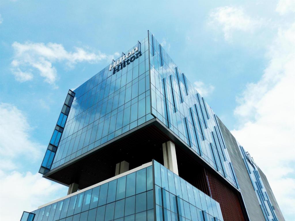 a building with a sign on top of it at Hilton Monterrey Valle in Monterrey