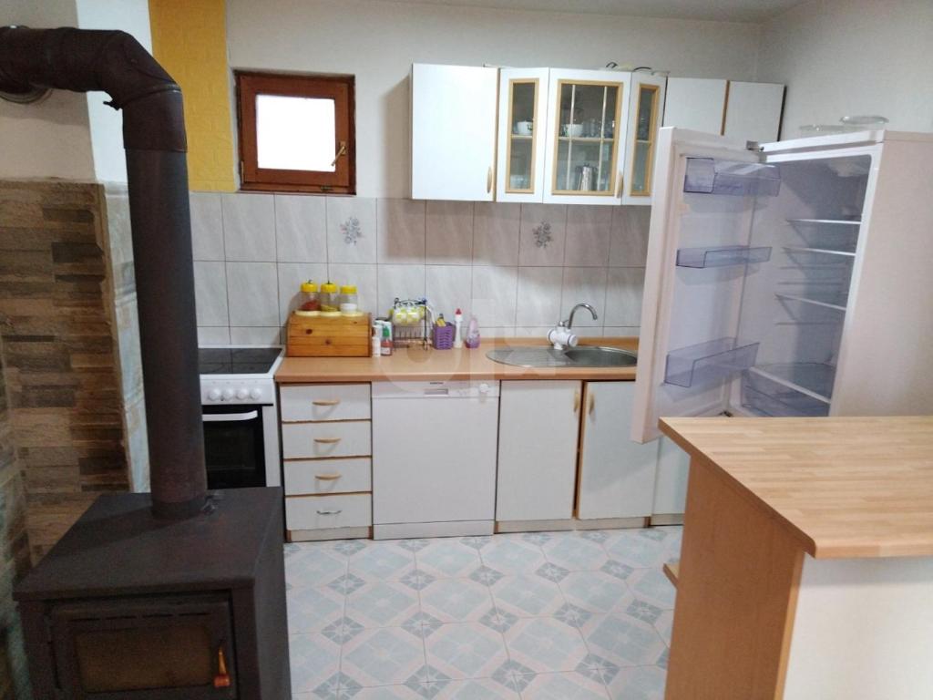 a kitchen with a stove in the middle of it at Bastion House with a bih garden in Bojnik