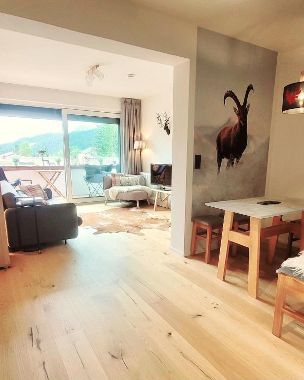 a living room with a goat painting on the wall at ALPartement Seefeld in Seefeld in Tirol