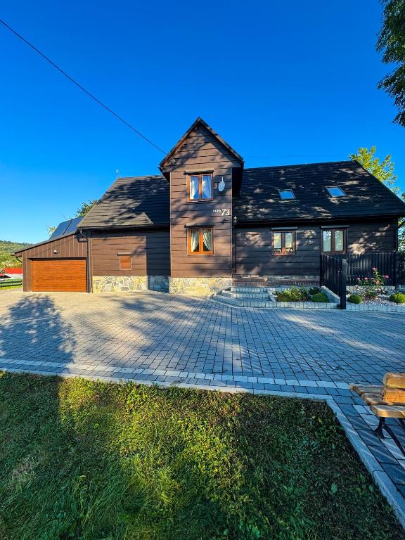 a house with a brick driveway in front of it at Beskid House Kurów in Kurów